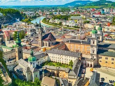 Austria: Historic lakeside village with alpine architecture and mountain backdrop.