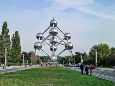 Belgium: Atomium structure with surrounding greenery under blue sky.