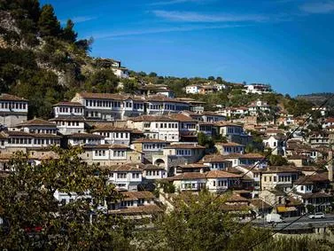 Berat Travel Guide: UNESCO World Heritage site featuring historic Ottoman houses cascading down the hillside in Albania.