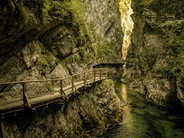 Dramatic gorge with steep cliffs and a river running through, illustrating the powerful forces of nature.