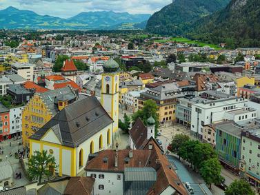 Kufstein, Austria. Elevated view of town with colorful buildings and St. Vitus Church.