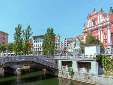 Ljubljana, Slovenia: Triple Bridge over Ljubljanica River with Franciscan Church backdrop.
