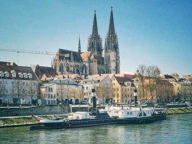 Regensburg, Germany. Gothic St. Peter's Cathedral towers over the Danube riverfront.
